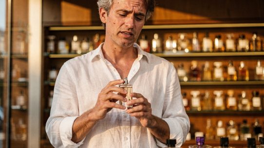 Homme tenant un flacon de parfum